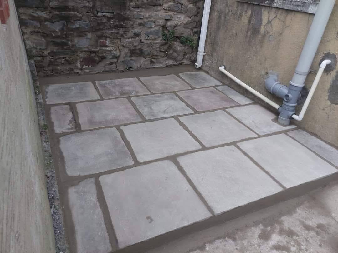 Little patio area created (perfect for a hot tub!) then extension fitted with composite cladding